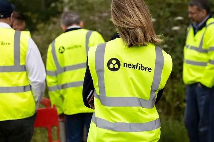 nexfibre team members in branded high-visibility vests on site